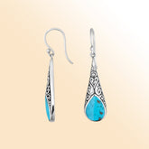 Silver teardrop earrings featuring Turquoise Shell and ornate Bali scroll patterns.
